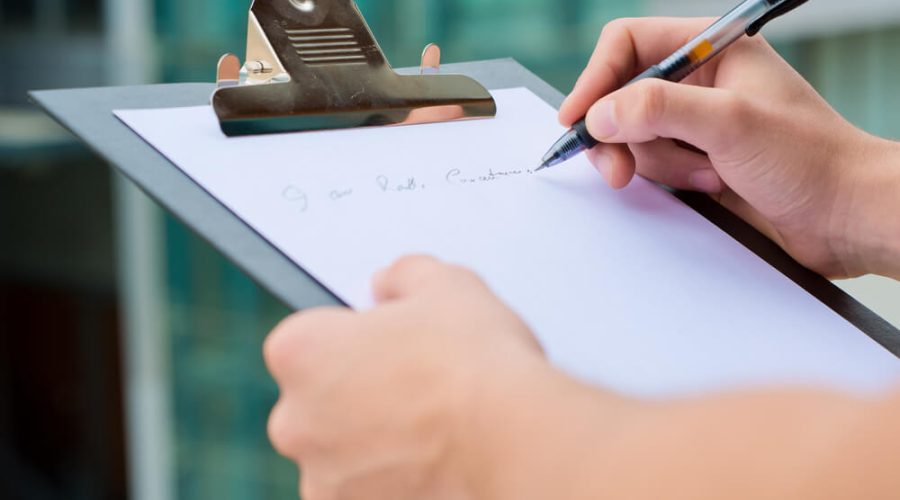 Homeowner reviewing a checklist for hiring an outdoor living contractor on a backyard deck project in Cincinnati OH